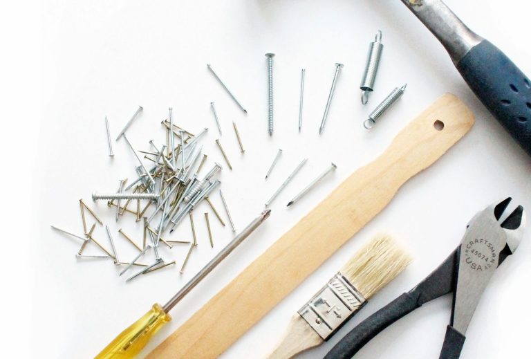 Assorted tools including screws, a screwdriver, a paintbrush, and pliers.