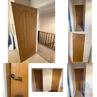 Wooden door with an arched top, situated in a hallway with carpeted floor.