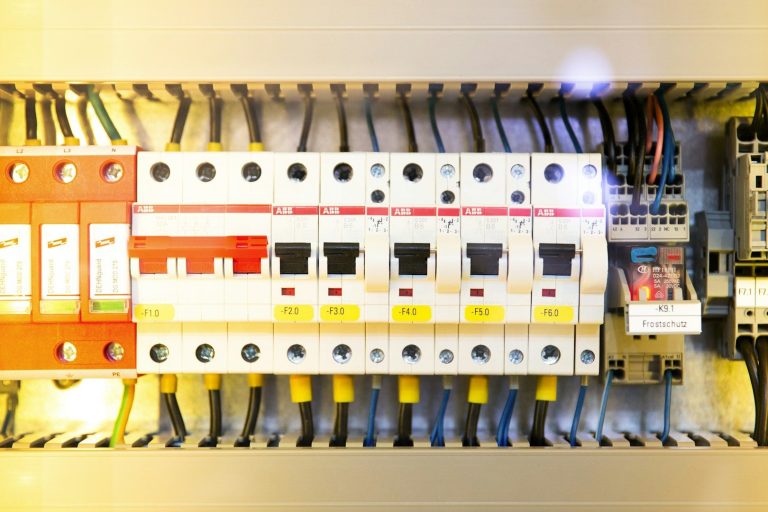Electrical circuit breaker panel with various switches and wiring components.